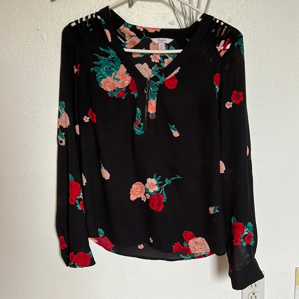 Black blouse with red and pink flowers with slits on the shoulders. Worn once.